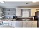 Bright kitchen featuring white cabinets, stainless steel appliances, and eat-in dining area at 2573 Mistletoe Ln, Snellville, GA 30039