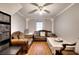 Living room with hardwood floors, two leather sofas, a window, and a ceiling fan with a light at 2573 Mistletoe Ln, Snellville, GA 30039