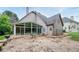 Backyard with stone patio, seating, grill, and sunroom attached to house at 6065 Standard View Dr, Duluth, GA 30097