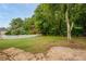 Large backyard featuring lush greenery, white picket fence, and stone patio at 6065 Standard View Dr, Duluth, GA 30097