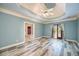The main bedroom features wood floors, a tray ceiling with fan, and doors to the outside at 6065 Standard View Dr, Duluth, GA 30097