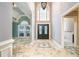 Spacious foyer with tiled floor, soaring ceilings, and beautiful chandelier and front door at 6065 Standard View Dr, Duluth, GA 30097