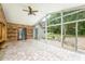 Bright sunroom with stone accent wall, brick floor, fan, and sliding glass doors to backyard at 6065 Standard View Dr, Duluth, GA 30097
