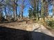 Large backyard with mature trees and a driveway at 1457 Richland Road Southwest, Atlanta, GA 30310