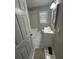 A full bathroom features tiled floors and walls, with a bright window and vanity with sink at 1457 Richland Road Southwest, Atlanta, GA 30310