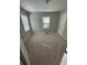 This bedroom features neutral walls, carpeted floors, two windows with blinds, and a white door at 1457 Richland Road Southwest, Atlanta, GA 30310