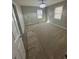 A carpeted bedroom features neutral walls, bright windows, and an elegant chandelier at 1457 Richland Road Southwest, Atlanta, GA 30310