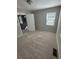 This bedroom features neutral walls, carpeted floors, one window with blinds, and a white door at 1457 Richland Road Southwest, Atlanta, GA 30310
