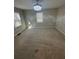 A carpeted bedroom features neutral walls, bright windows, and an elegant chandelier at 1457 Richland Road Southwest, Atlanta, GA 30310