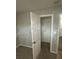 A carpeted walk-in closet offers plenty of shelving and storage space at 1457 Richland Road Southwest, Atlanta, GA 30310