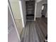 Inviting entryway featuring wood-look floors and a custom built-in bench with a decorative wood accent wall at 1457 Richland Road Southwest, Atlanta, GA 30310