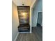 Inviting entryway featuring wood-look floors and a custom built-in bench with a decorative wood accent wall and pendant light at 1457 Richland Road Southwest, Atlanta, GA 30310