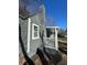 This charming home features a gray brick chimney, gray horizontal siding, and a cozy front porch with white railings at 1457 Richland Road Southwest, Atlanta, GA 30310