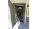 View of the front door featuring a decorative security gate and gray brick and siding at 1457 Richland Road Southwest, Atlanta, GA 30310