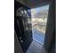 A black front door with a window opens to an elevated deck and backyard at 1457 Richland Road Southwest, Atlanta, GA 30310