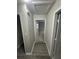 A hallway leads to other rooms, showcasing the home's neutral color palette and laminate flooring at 1457 Richland Road Southwest, Atlanta, GA 30310