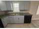 Gray kitchen featuring stainless steel double sinks and granite countertops at 1457 Richland Road Southwest, Atlanta, GA 30310