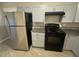 Modern kitchen featuring stainless steel refrigerator and a black electric range at 1457 Richland Road Southwest, Atlanta, GA 30310