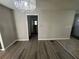 Charming living room featuring hardwood flooring and a decorative chandelier at 1457 Richland Road Southwest, Atlanta, GA 30310