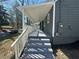 Exterior view of the side porch and entrance featuring painted steps and white railings at 1457 Richland Road Southwest, Atlanta, GA 30310