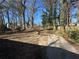 The backyard is spacious with a gravel driveway providing ample parking or play space and shade trees at 1457 Richland Sw Rd, Atlanta, GA 30310