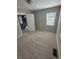Bright bedroom with neutral carpet, a window, and a view to the entryway at 1457 Richland Sw Rd, Atlanta, GA 30310