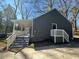 Side view of a gray home featuring a covered porch with steps at 1457 Richland Sw Rd, Atlanta, GA 30310