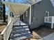 Side view of the covered porch and staircase with clean white pillars to enter the house at 1457 Richland Sw Rd, Atlanta, GA 30310