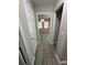 Hallway featuring gray wood-look floors and a chandelier in the next room at 1457 Richland Sw Rd, Atlanta, GA 30310