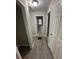 Hallway with grey floors and doorways to the powder room, bedroom, and attic at 1457 Richland Sw Rd, Atlanta, GA 30310