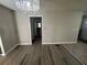 The living room features a decorative chandelier and laminate flooring at 1457 Richland Sw Rd, Atlanta, GA 30310