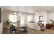 Open-concept living and dining area with hardwood floors, fireplace, and plenty of natural light at 55 Alameda St # 6, Loganville, GA 30052