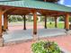 Outdoor pavilion featuring wood support beams, a concrete floor, and a stone base at 55 Alameda St # 6, Loganville, GA 30052