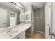 Bright bathroom features a large mirror, white vanity, and convenient towel racks at 1995 Liberty Hts, Fairburn, GA 30213