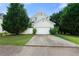 View of the back of the house with a spacious two-car garage and driveway at 1995 Liberty Hts, Fairburn, GA 30213
