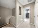 Upstairs hallway with carpet and view into bedroom with dark accent wall at 1995 Liberty Hts, Fairburn, GA 30213