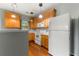 Well-lit kitchen features wood floors, stainless appliances, and light wood cabinetry at 1995 Liberty Hts, Fairburn, GA 30213