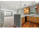 Well-lit kitchen with natural wood cabinets and open layout to living area at 1995 Liberty Hts, Fairburn, GA 30213