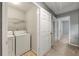 Laundry room with washer, dryer, and wire shelving at 1995 Liberty Hts, Fairburn, GA 30213