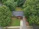 Aerial view of a home nestled among mature trees with a well-manicured lawn at 3510 Dunn Se St, Smyrna, GA 30080