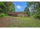Lush backyard features a multi-level deck and a gently sloping lawn surrounded by mature trees at 3510 Dunn Se St, Smyrna, GA 30080