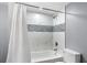 Updated bathroom with tub and shower combination and decorative tile at 3510 Dunn Se St, Smyrna, GA 30080