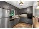 Efficient kitchen with stainless steel appliances, dark cabinetry, and an undermounted sink at 3510 Dunn Se St, Smyrna, GA 30080