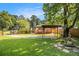 A spacious backyard with a wooden carport, a fountain, and a deck at 961 Lindbergh Ne Dr, Atlanta, GA 30324