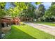 A spacious backyard with a driveway leading to a carport and a deck on the side of the home at 961 Lindbergh Ne Dr, Atlanta, GA 30324