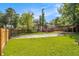 A well-manicured backyard features a wooden carport and a fenced perimeter at 961 Lindbergh Ne Dr, Atlanta, GA 30324