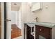 Stylish bathroom features a glass countertop vanity with hardwood floors at 961 Lindbergh Ne Dr, Atlanta, GA 30324
