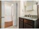 Bathroom with granite countertop vanity, stylish faucet, tile floors, and entry to other rooms at 961 Lindbergh Ne Dr, Atlanta, GA 30324