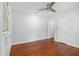 A cozy bedroom with hardwood floors, a ceiling fan, and a window A/C unit at 961 Lindbergh Ne Dr, Atlanta, GA 30324