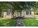Charming single-story home with painted brick, black shutters, manicured lawn and walkway at 961 Lindbergh Ne Dr, Atlanta, GA 30324